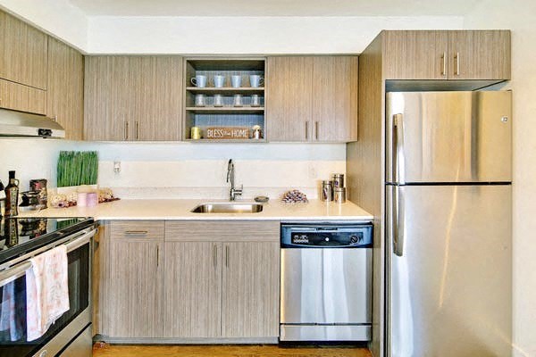 a kitchen with stainless steel appliances and wooden cabinets