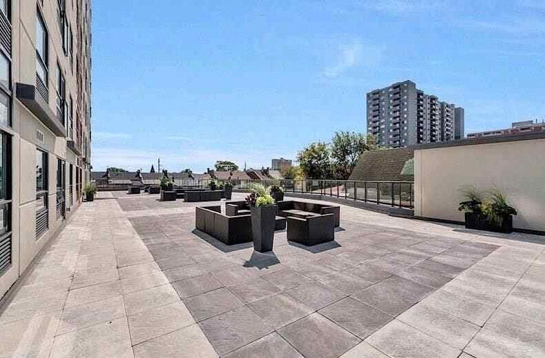 a roof terrace with benches and a building