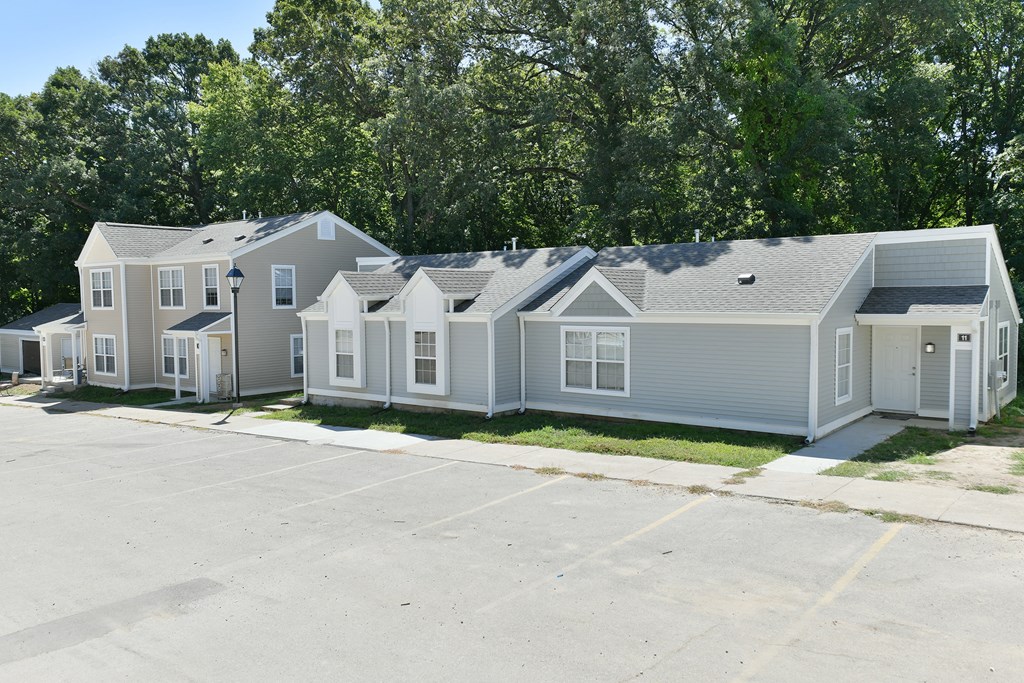 a row of houses with a parking lot in front of them