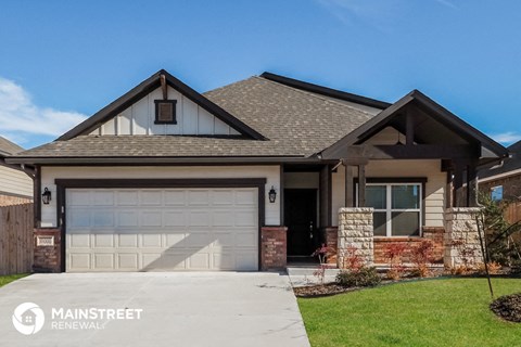 a home with a garage door in front of it