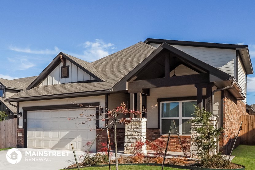 a house with a garage door and a porch
