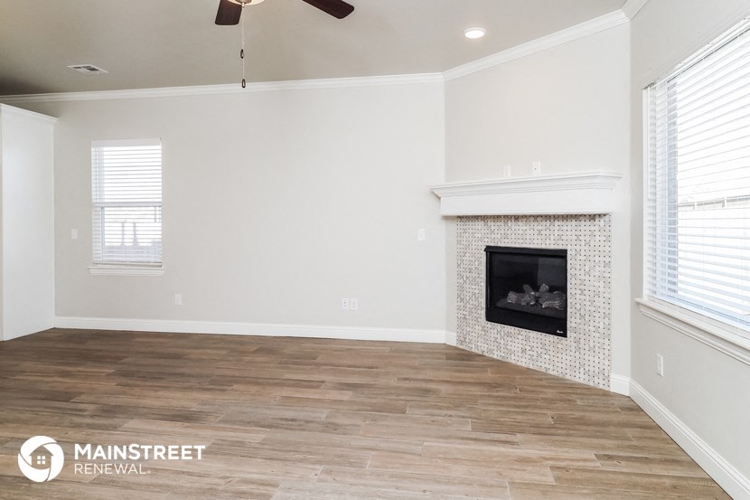 the living room of a new home with a fireplace