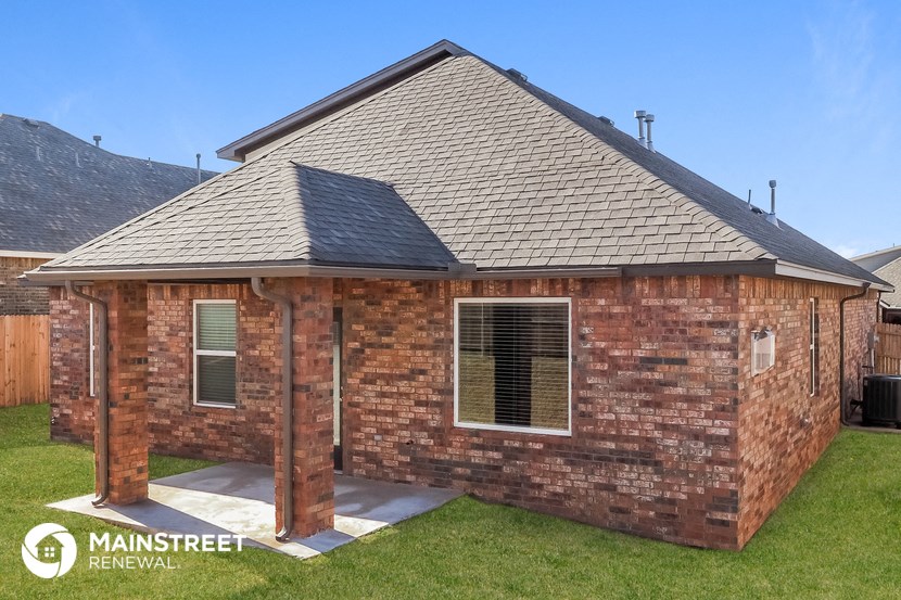 the view of a brick house from the front yard
