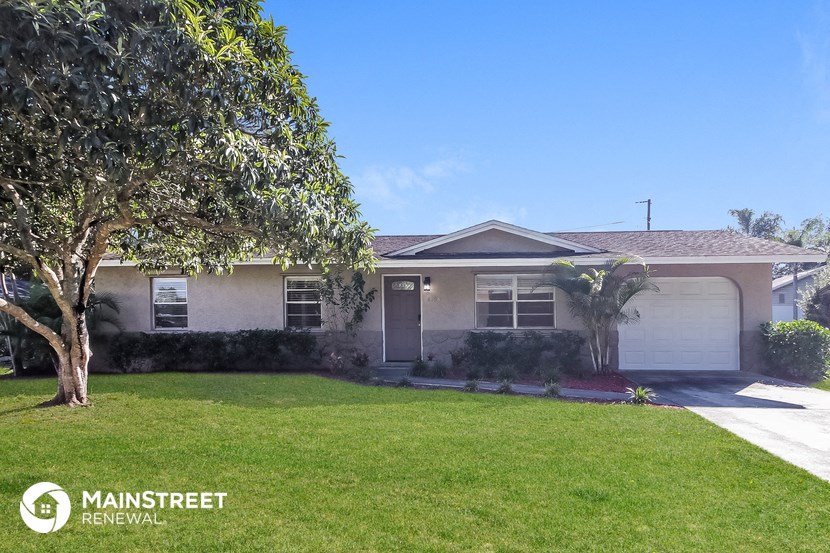 a house with a lawn and a palm tree