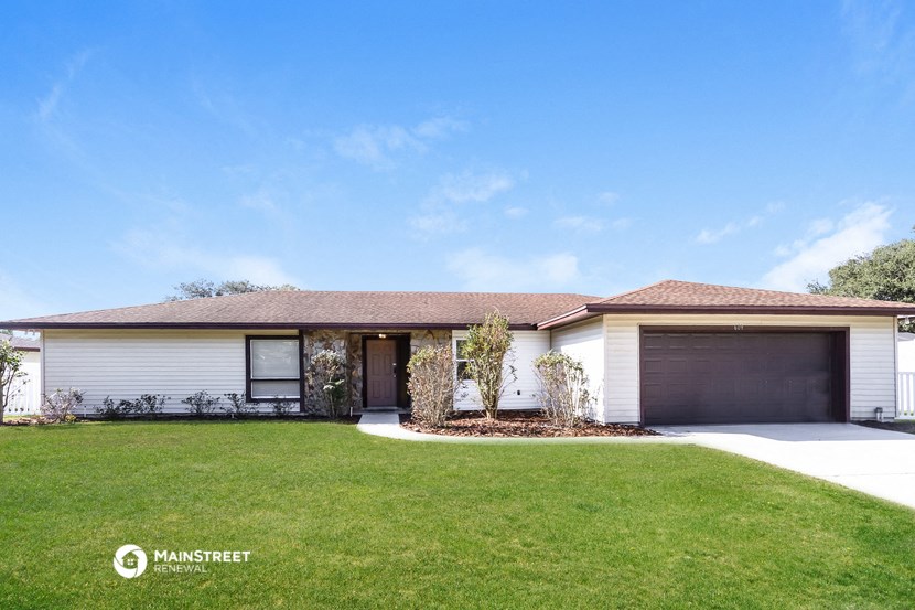 a white house with a lawn in front of it