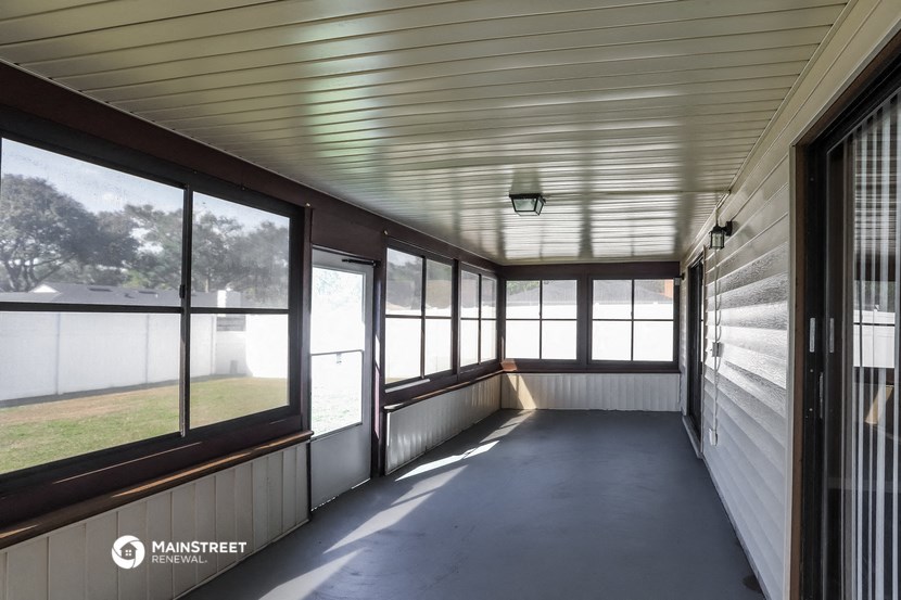 a view of the porch of a house with large windows