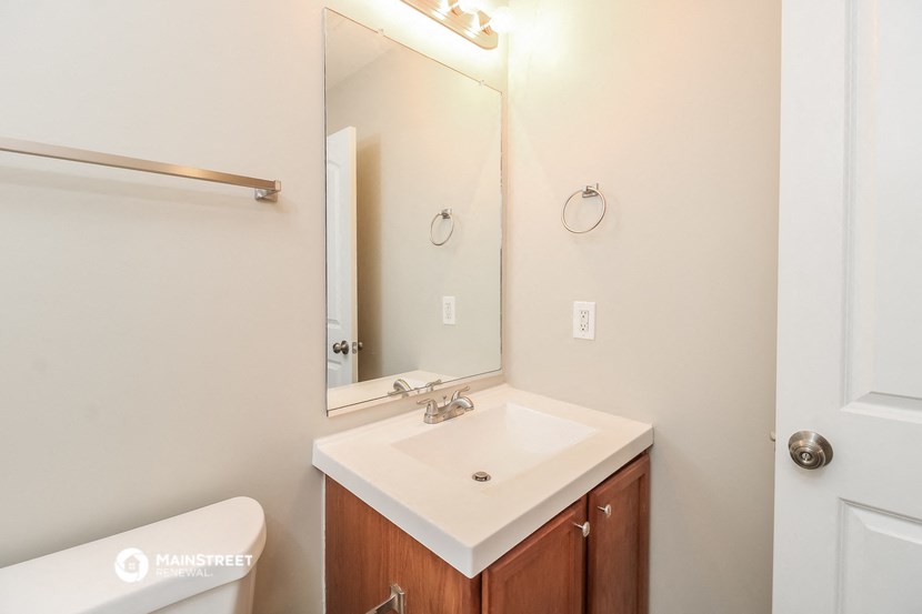 a bathroom with a sink and a mirror and a toilet