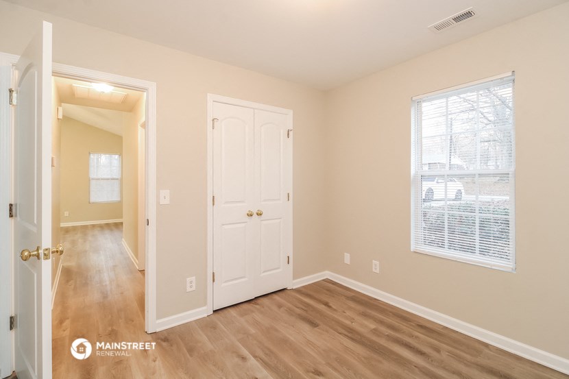 a bedroom with a door and a door to a hallway