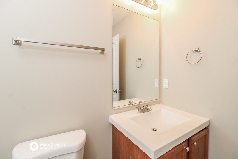 a bathroom with a sink and a mirror and a toilet