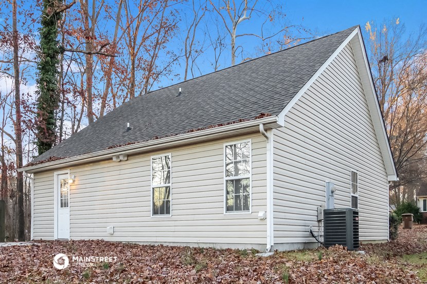 the front of a white house with a gray roof