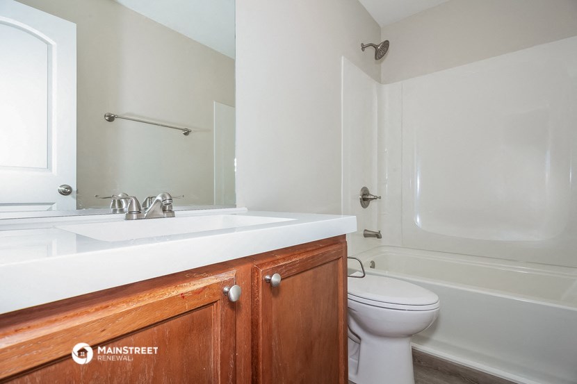 a bathroom with a sink toilet and a bath tub