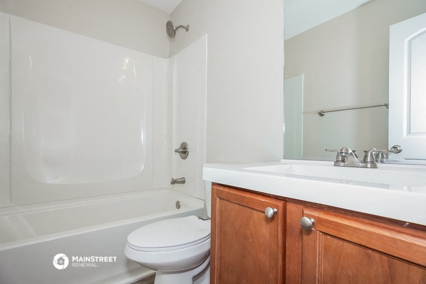 a bathroom with a sink toilet and a bath tub