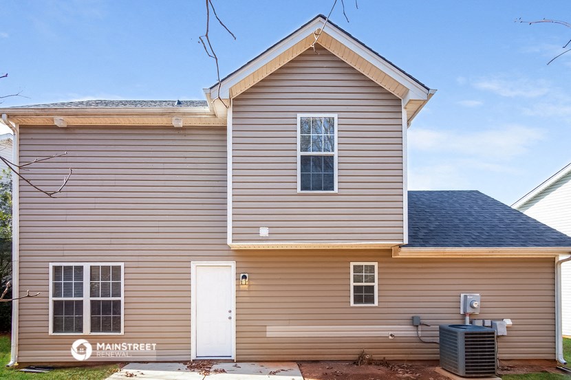 a brown house with a blue sky behind it