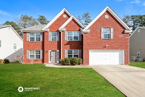 a red brick house with a white garage door