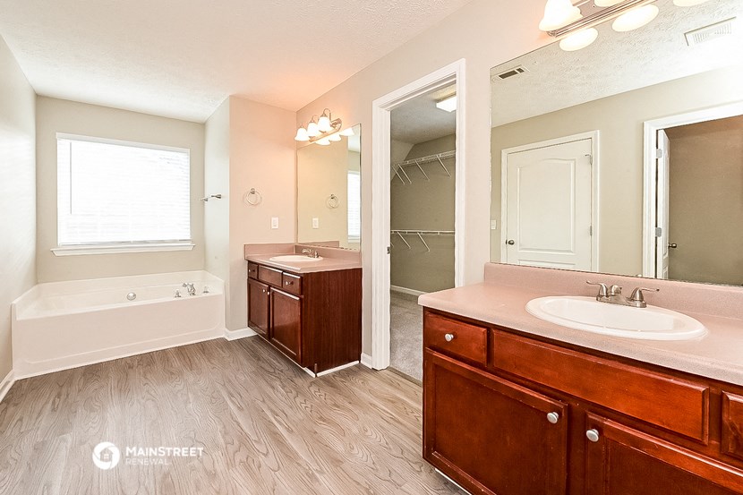 a bathroom with a sink and a tub and a mirror
