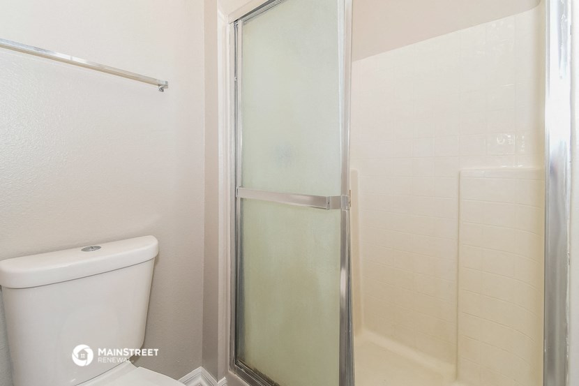 a bathroom with a shower and a toilet