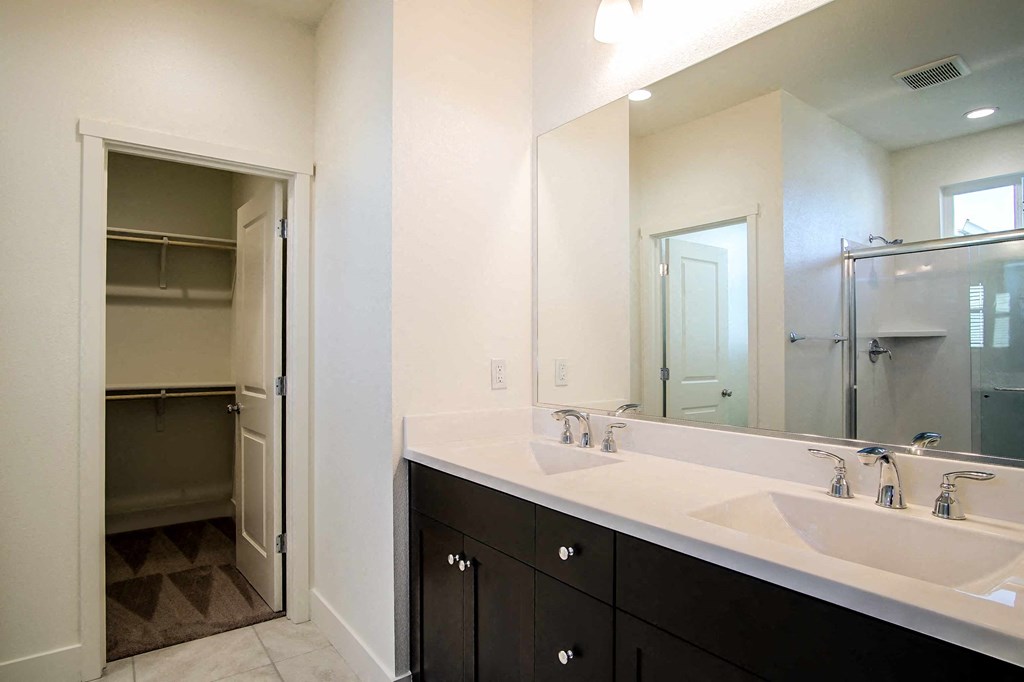 a bathroom with two sinks and a large mirror
