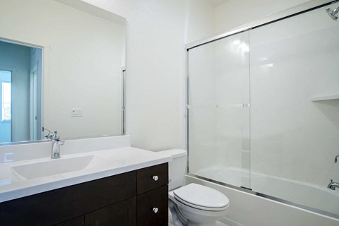 a bathroom with a sink toilet and shower