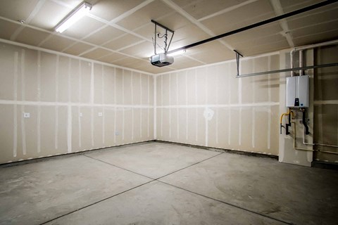 a large empty room with white walls and a tile floor