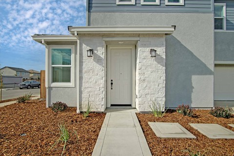 the front of a house with a white door