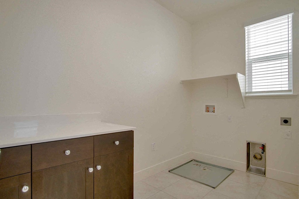 an empty kitchen with a sink and a window