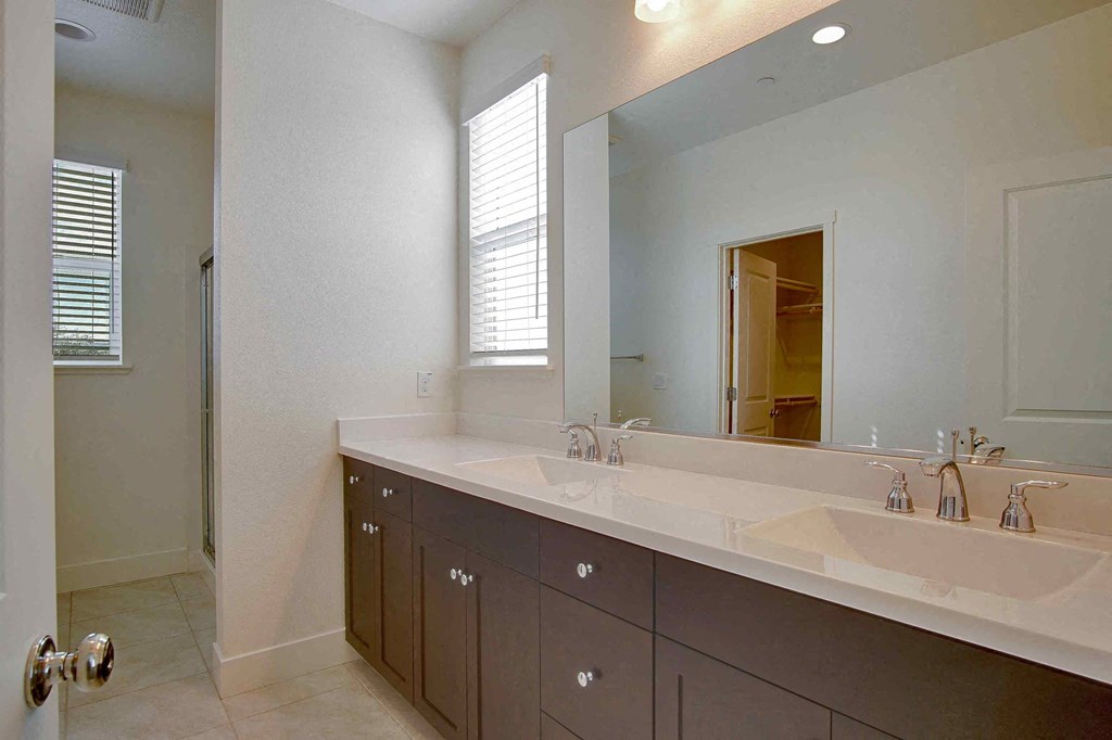 a bathroom with two sinks and a large mirror