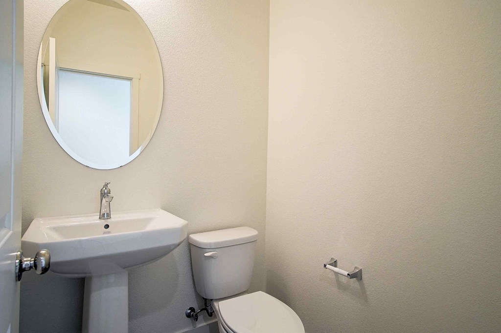 a bathroom with a sink and a toilet and a mirror