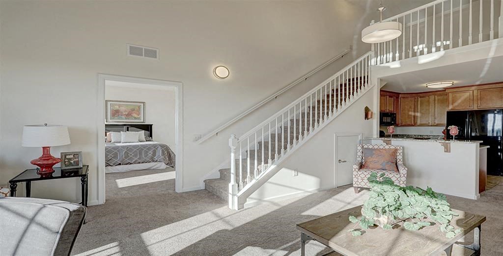 a living room with a staircase and a couch
