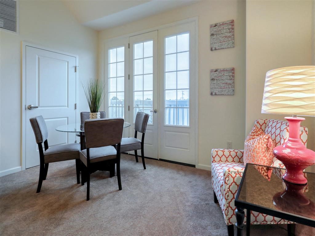 a living room with a table and chairs