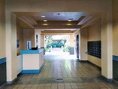 A hallway with a blue and white reception desk.