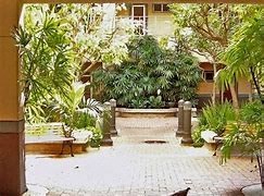 A courtyard with a bench and a bird.