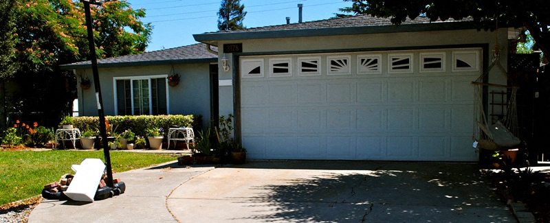 A white garage door is closed.