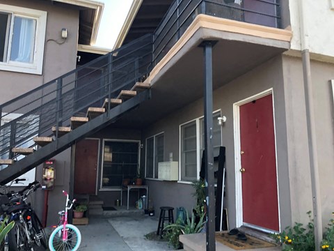 the outside of our house with our stairs and the red door