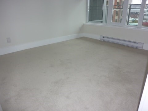 A room with a window and a radiator on the wall.