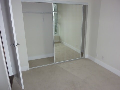 A room with a white door and a glass door.