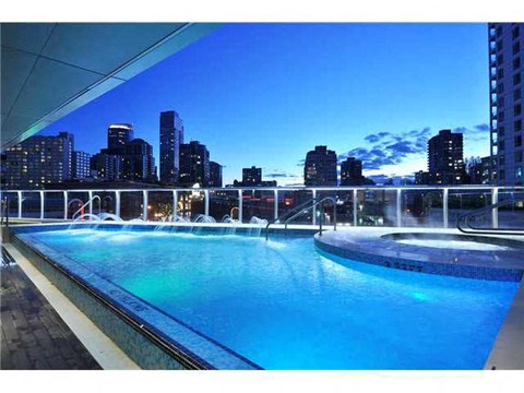 a pool with a view of a city at night