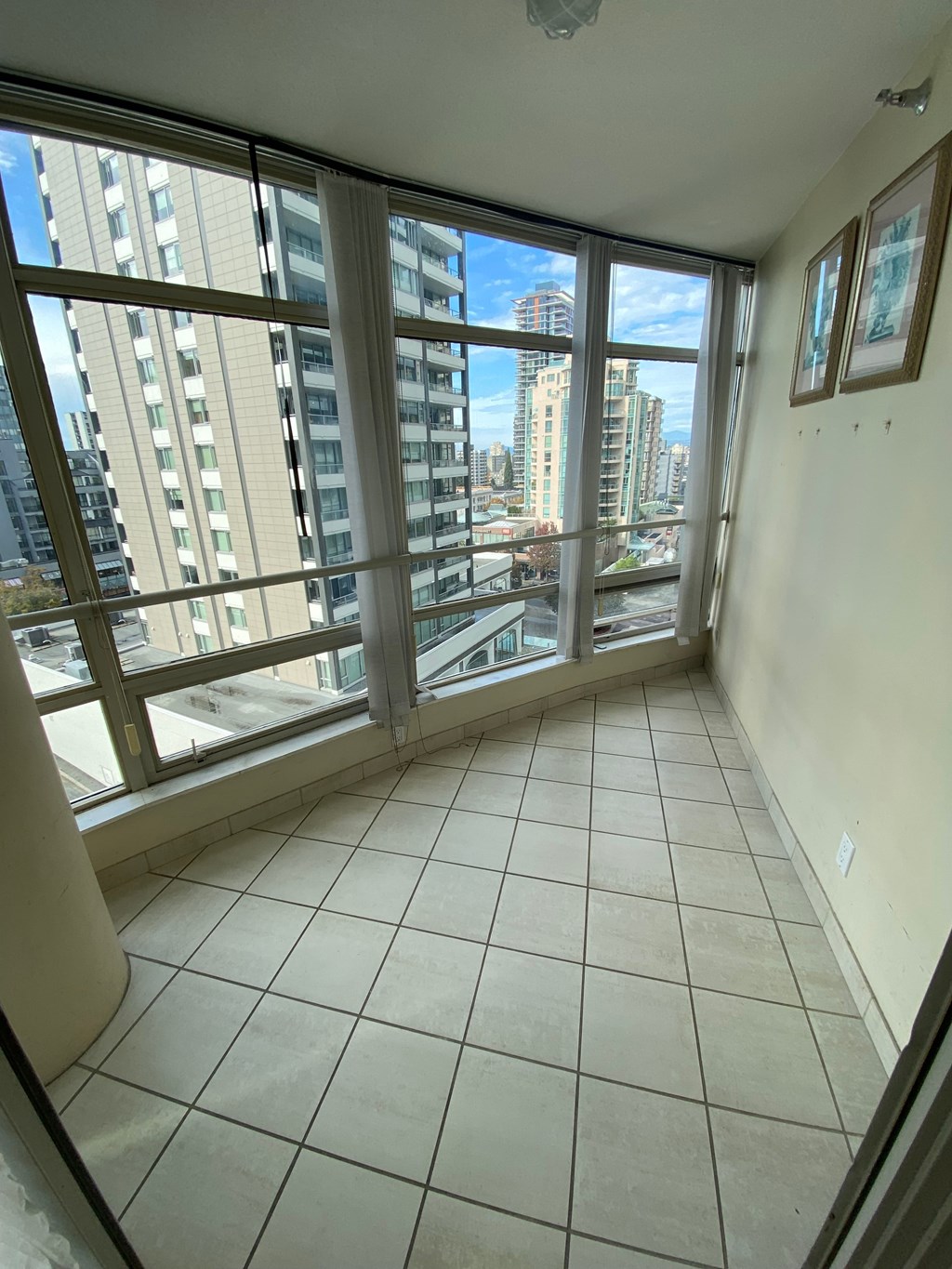 A room with a large window overlooking a cityscape.