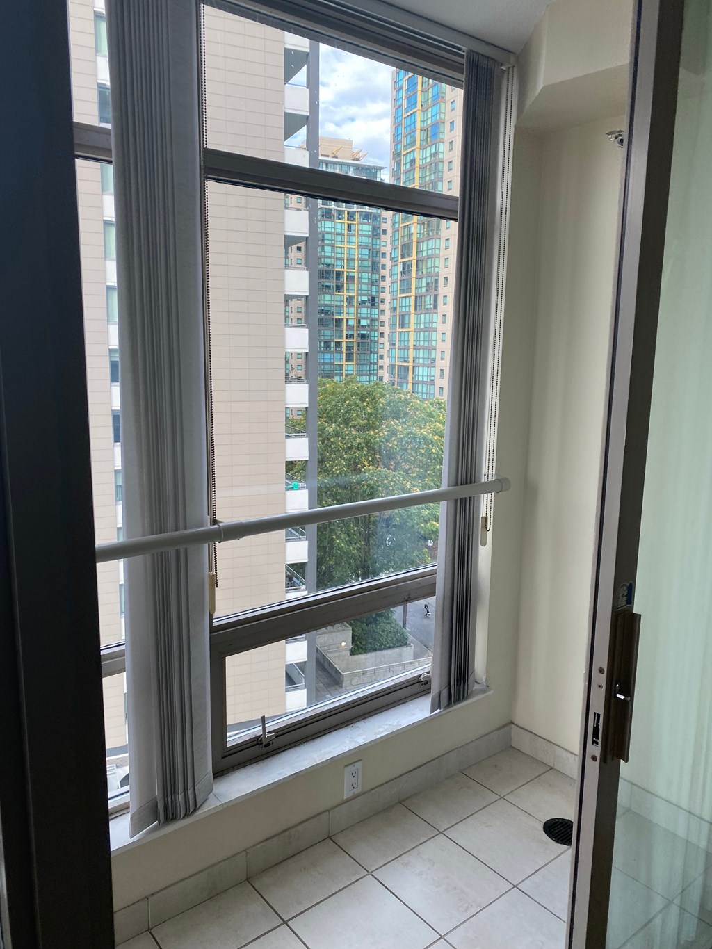 A view of a balcony with a glass door.