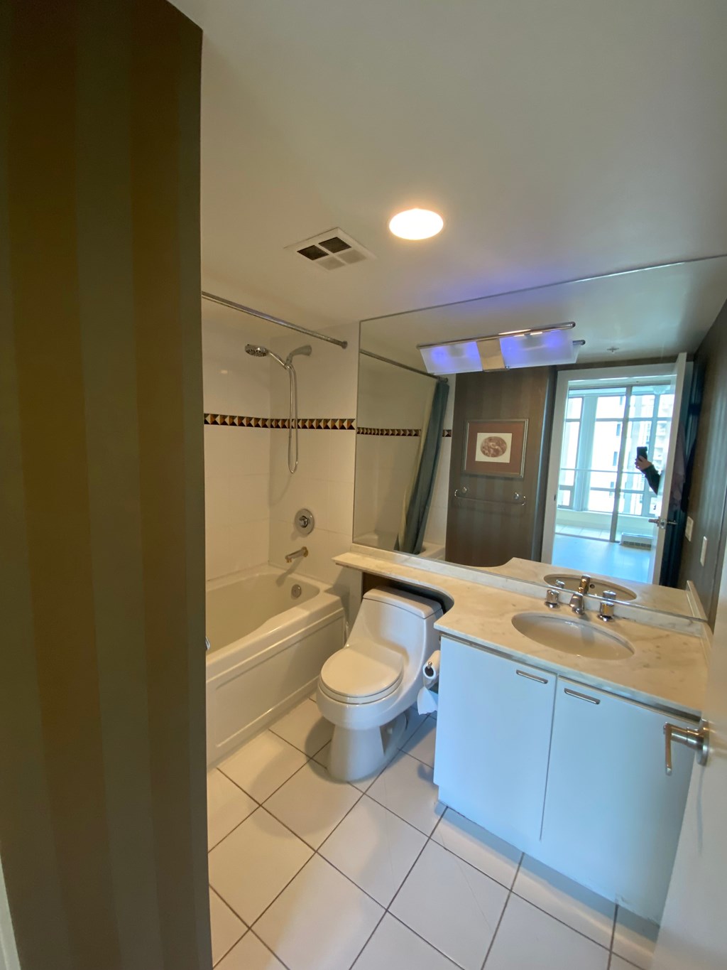 A white bathroom with a toilet, sink, and bathtub.