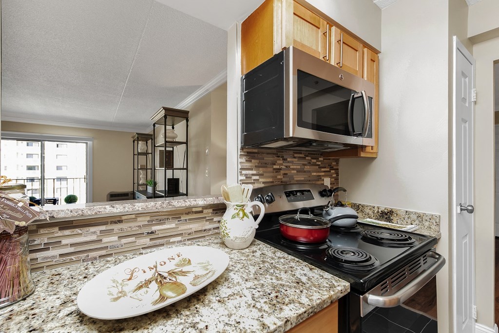 a kitchen with a stove top oven and a sink