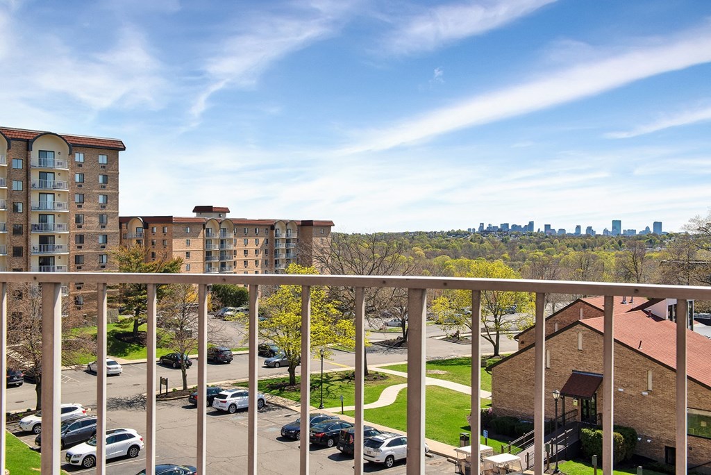 the view of the city from the balcony of an apartment building