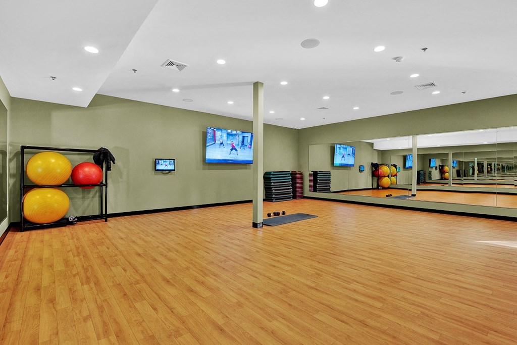 a bowling alley with bowling balls and a bowling ball rack in a large room with