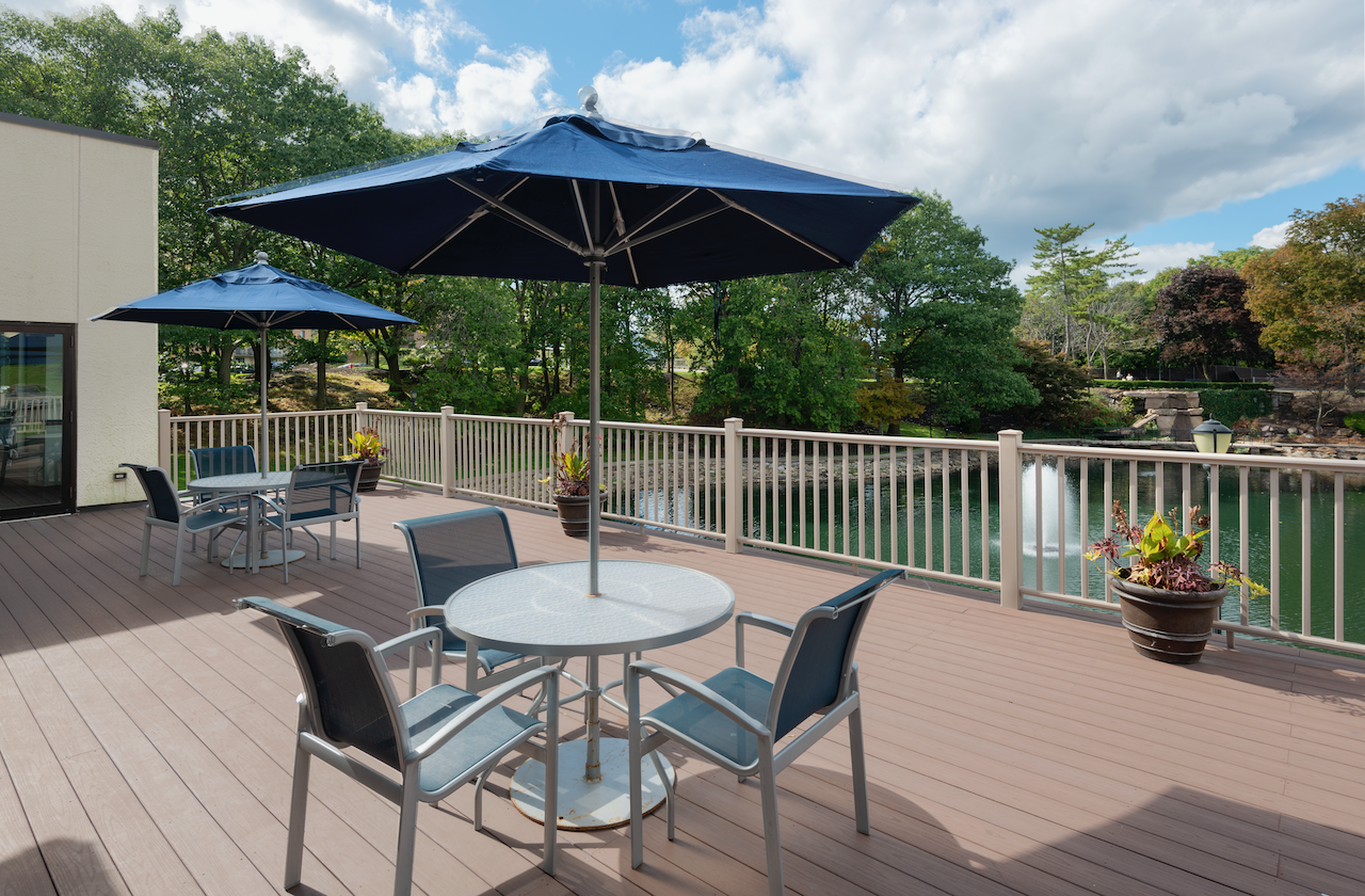 a patio with a table and chairs and an umbrella