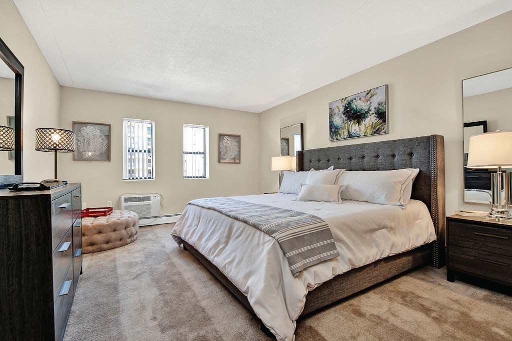 a bedroom with a bed and a dresser