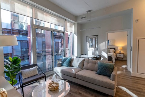 a living room with a couch and a glass table