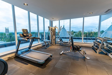 a gym with a view of the skyline