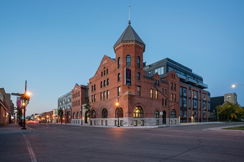 a large brick building on a city street at night