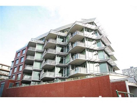 A large multi-story building with balconies on each floor.