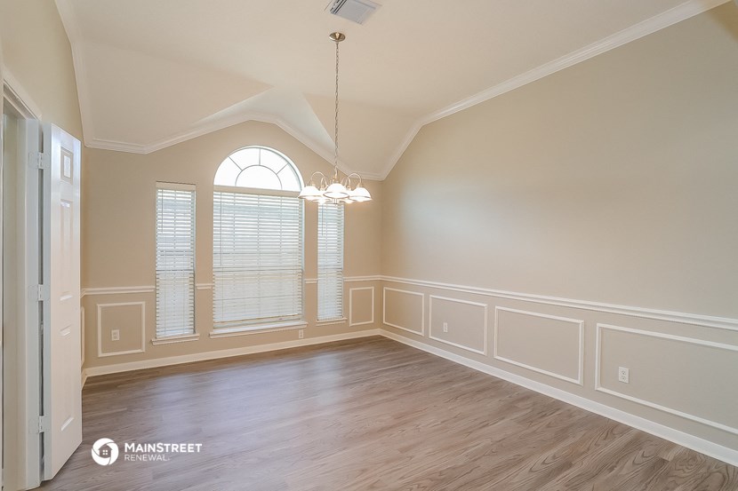an empty dining room with a large window