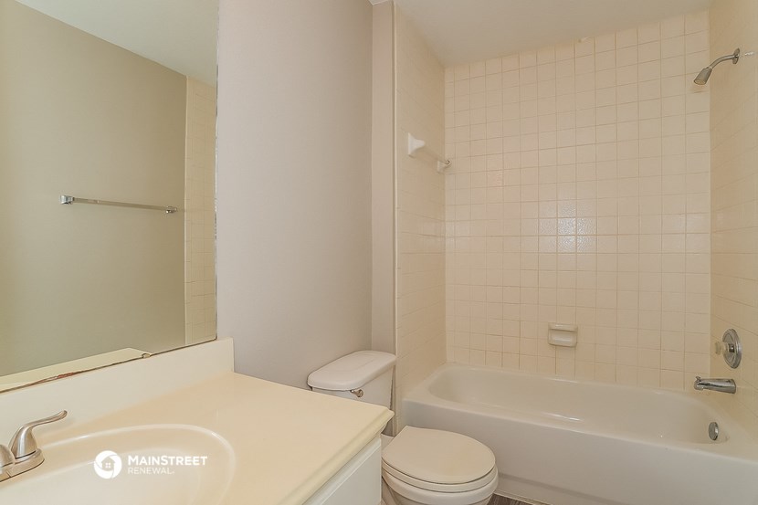 a bathroom with a sink toilet and a bath tub